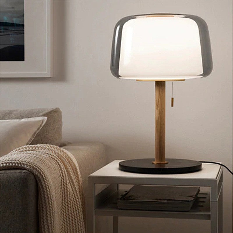 Front view of wood and glass table lamp on side table