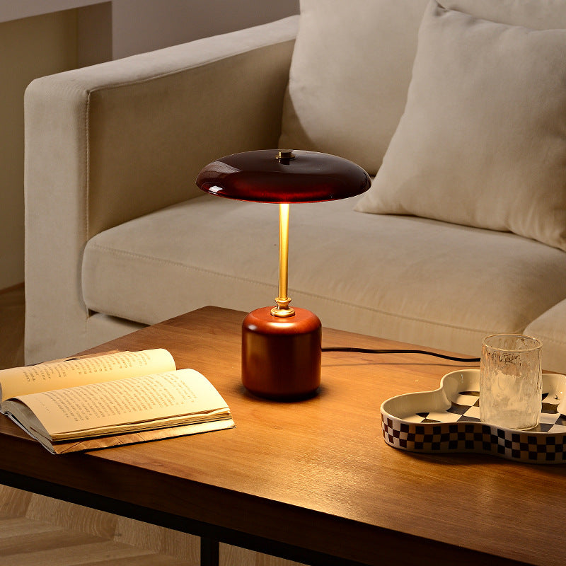 Lifestyle shot of burgundy mushroom lamp on coffee table in living room