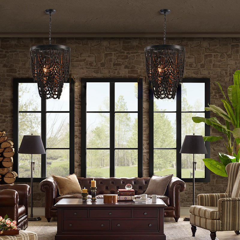Black wooden bead chandelier in rustic living room setting