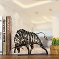 Side profile of woven metal bull sculpture on wooden shelf