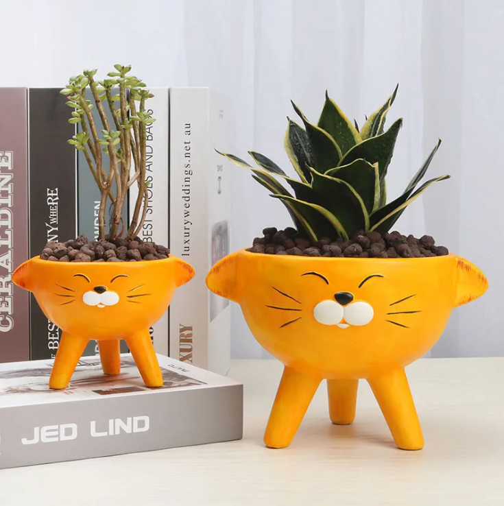 Comparison of large and medium ceramic cat planters