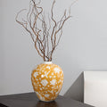 Yellow ceramic ginger jar with branches