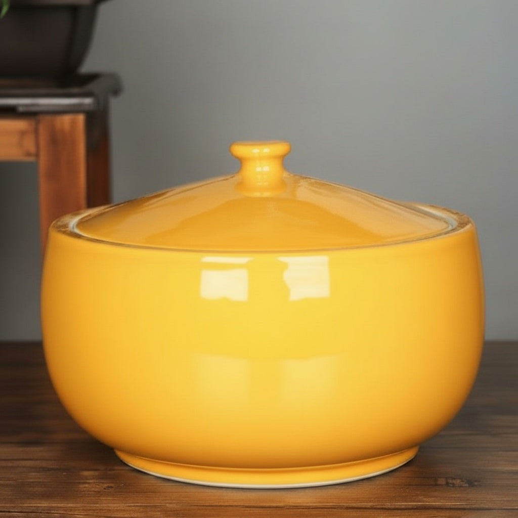 Yellow glazed ceramic round lidded bowl with closed lid