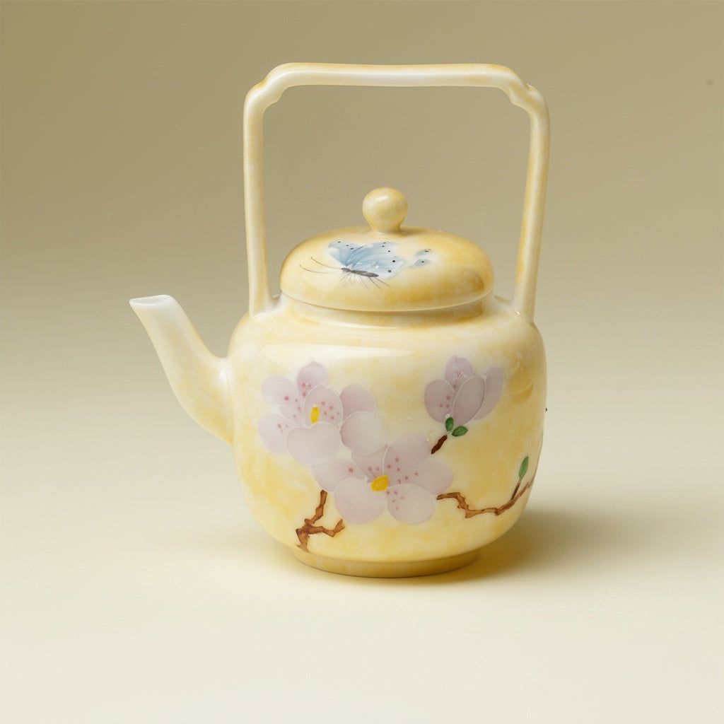 Yellow porcelain teapot with overhead handle
