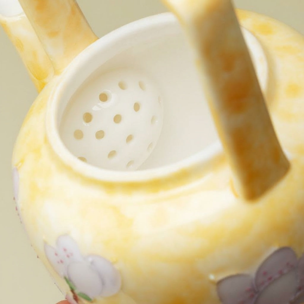 Built-in ceramic strainer inside yellow teapot