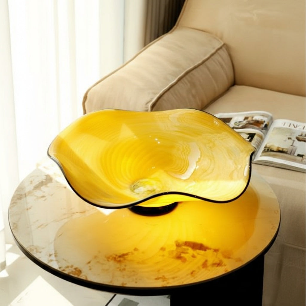 Empty yellow wavy glass bowl on marble surface